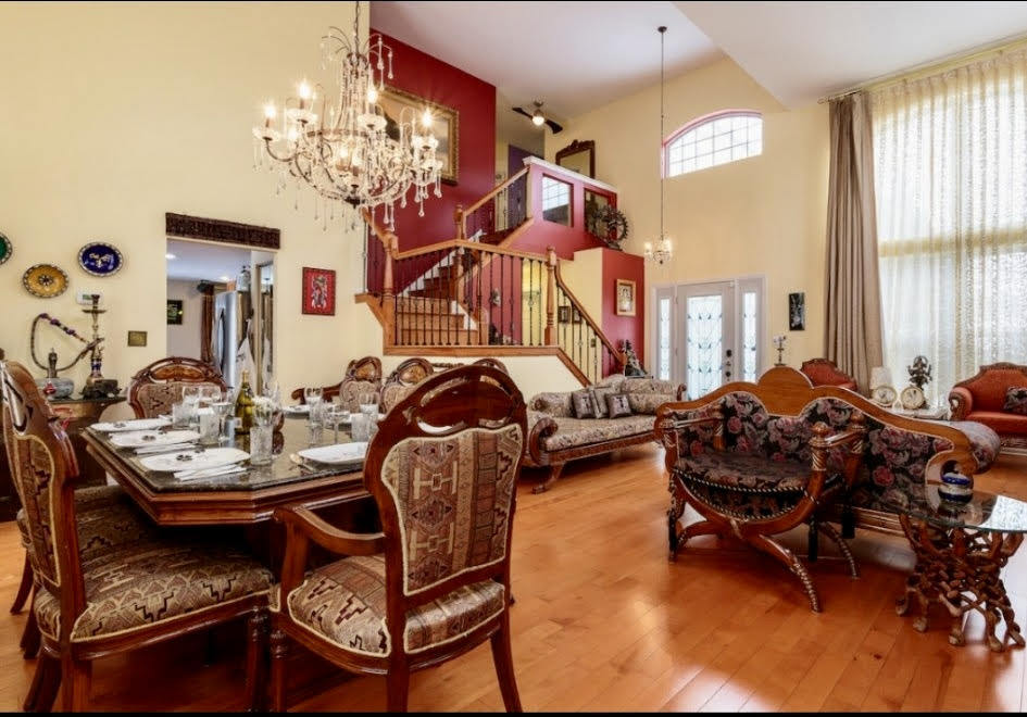 671 Wintergreen Circle Naperville, IL 60540 - Photo 2 of 17 a living room with furniture a window and a chandelier