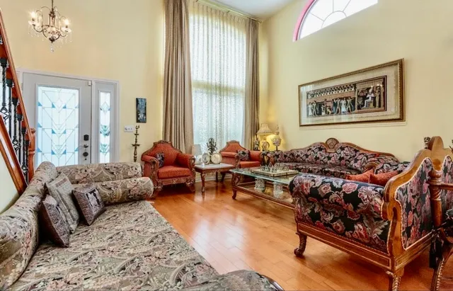 a living room with furniture a couch and large window