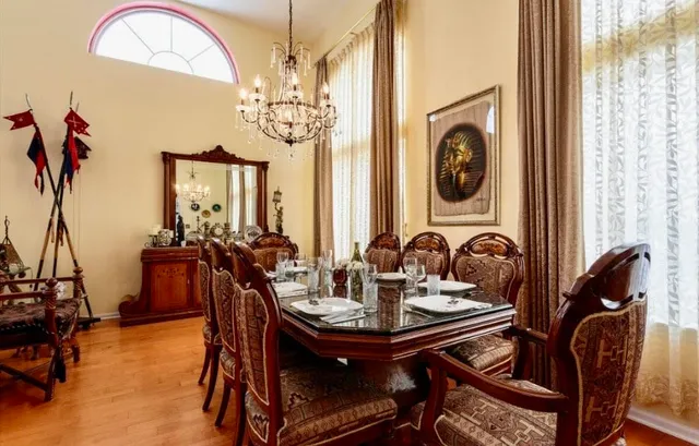 a view of a dining room with furniture and chandelier