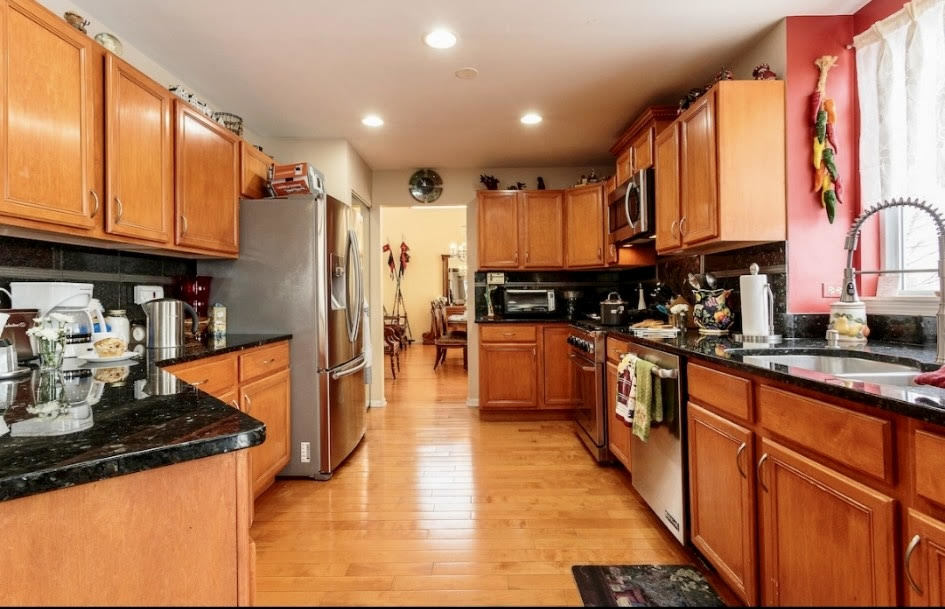 671 Wintergreen Circle Naperville, IL 60540 - Photo 5 of 17 a kitchen with stainless steel appliances granite countertop a refrigerator a stove top oven and cabinets