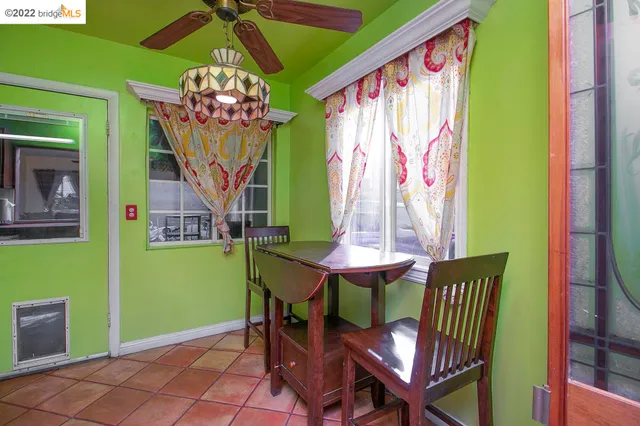 a view of a dining room with furniture and a chandelier