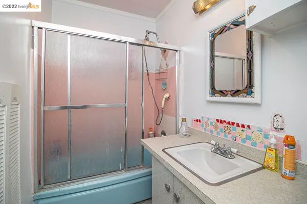 a bathroom with a sink vanity and a mirror