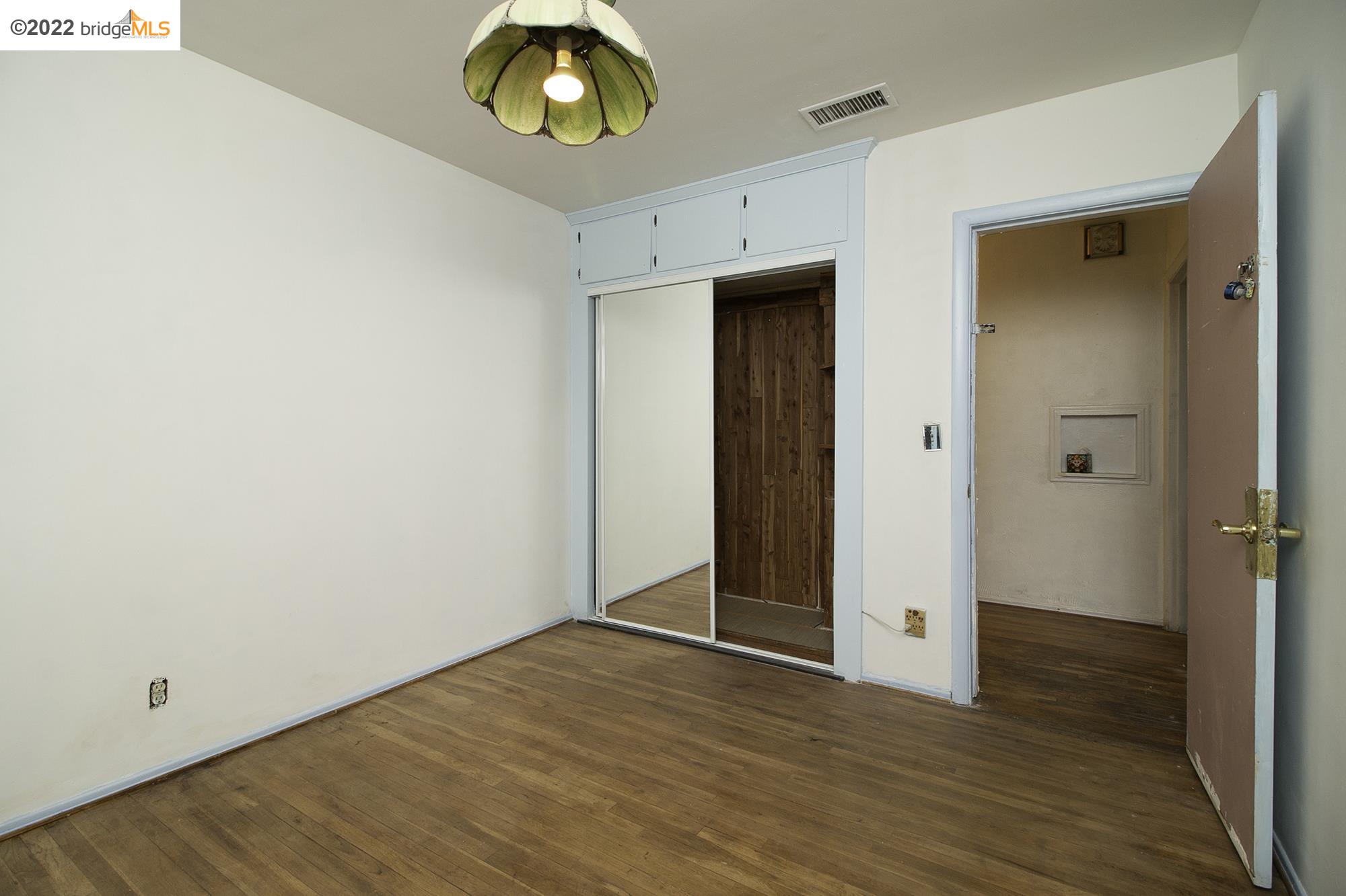 7755 Forsythe Street Tujunga, CA 91042 - Photo 7 of 15 a view of an empty room with wooden floor and closet
