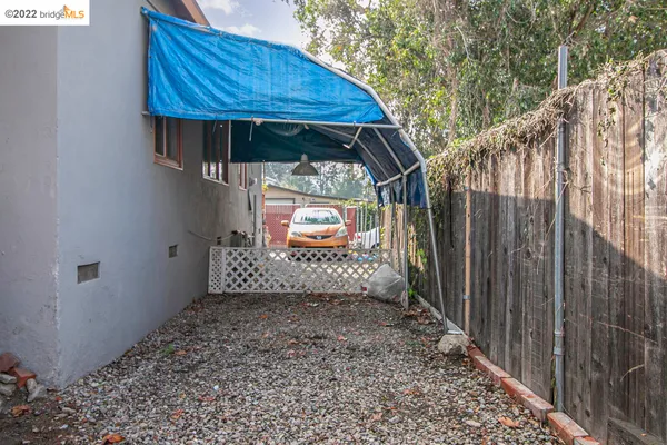 a view of a pathway of a house with wooden fence