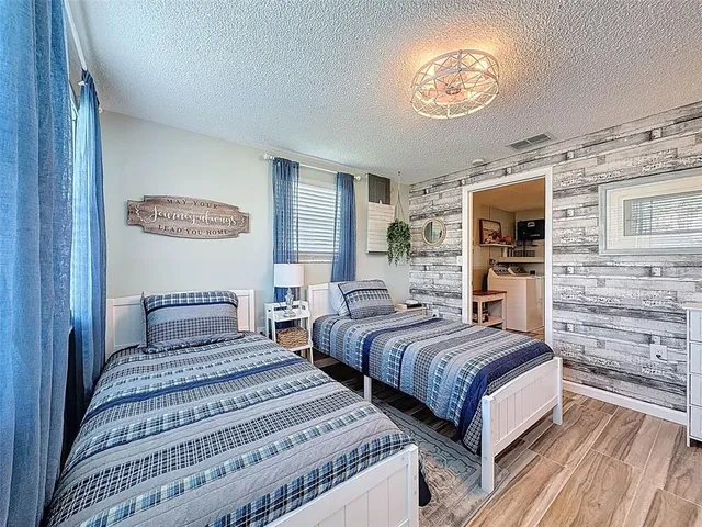 a view of a dining room with furniture a chandelier and wooden floor