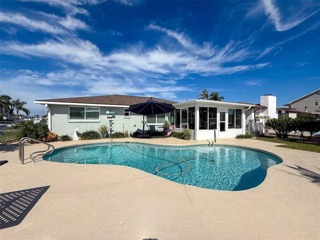 a spacious bedroom with a large bed and a chandelier