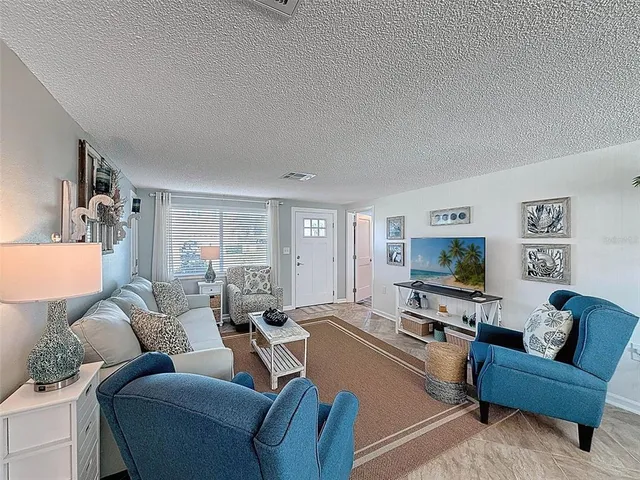 a bedroom with two beds and a chandelier