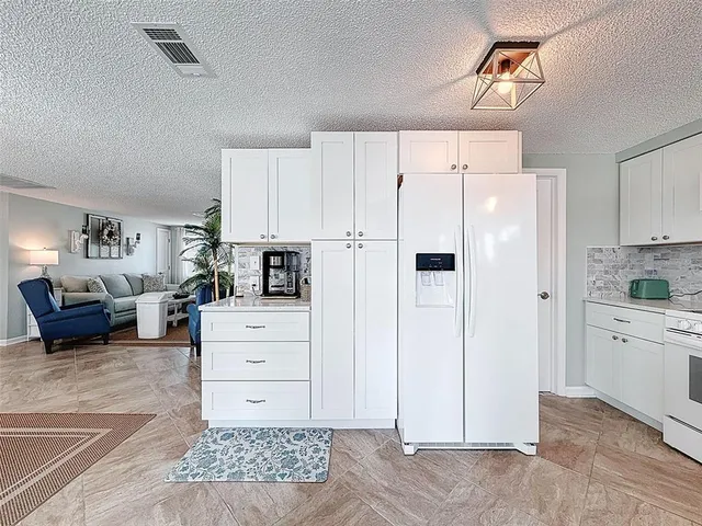 a living room with furniture a ceiling fan and a large window
