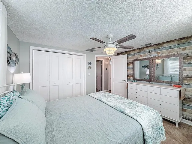 a view of a house with pool fire pit and chairs