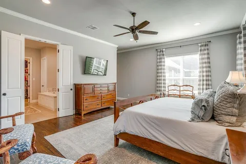 a bedroom with a bed a window and a couch