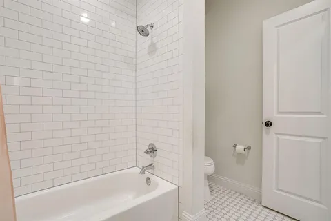 a bathroom with a bathtub and a toilet