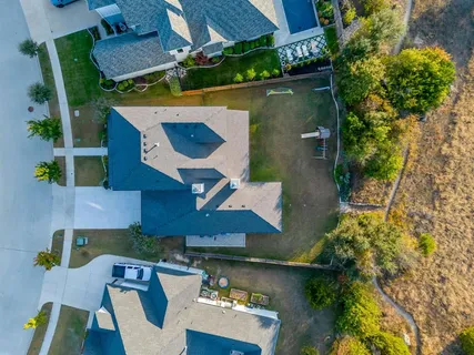 an aerial view of a house with swimming pool patio and outdoor seating