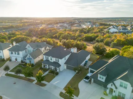 an aerial view of residential houses with outdoor space