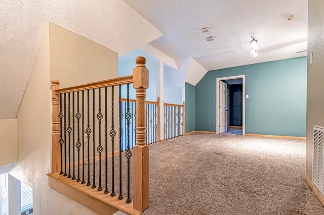 an empty room with fan and entrance