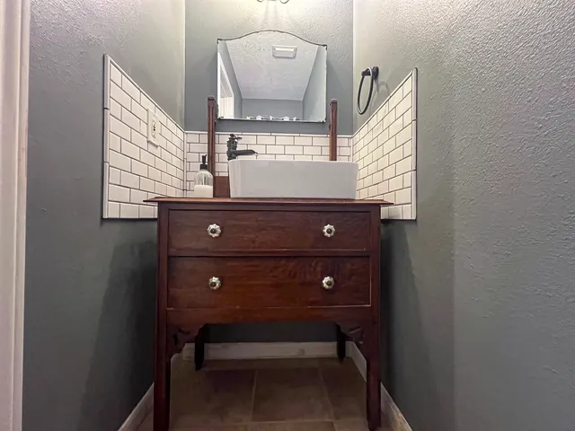 a kitchen with stainless steel appliances granite countertop a stove cabinets and wooden floor