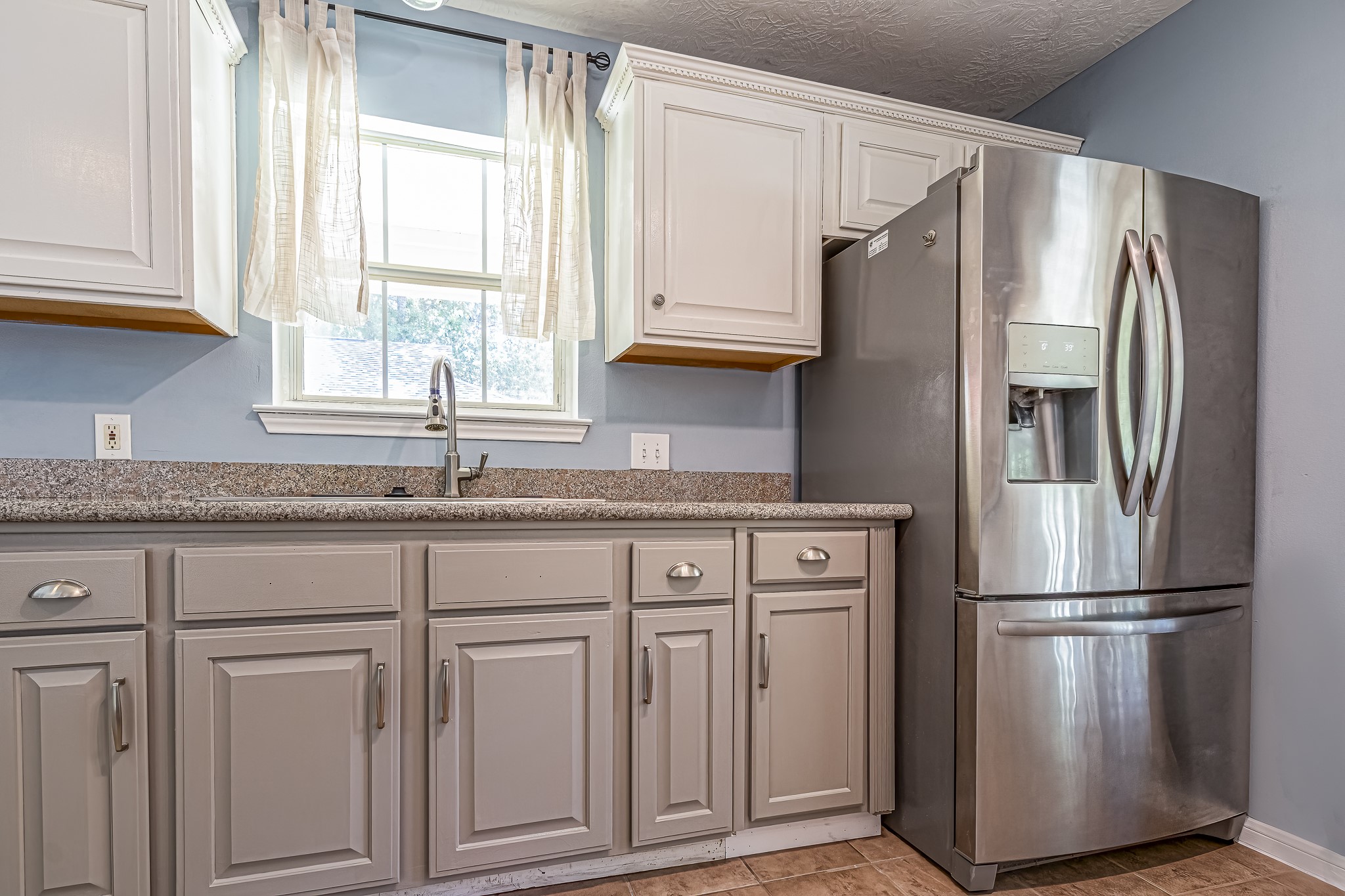 12 Quiet Wind Trinity, TX 75862 - Photo 26 of 47 a kitchen with stainless steel appliances granite countertop a refrigerator sink and cabinets