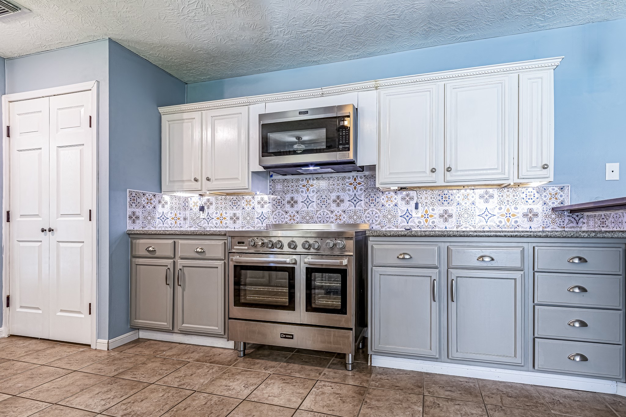 12 Quiet Wind Trinity, TX 75862 - Photo 28 of 47 a kitchen with granite countertop white cabinets stainless steel appliances and sink