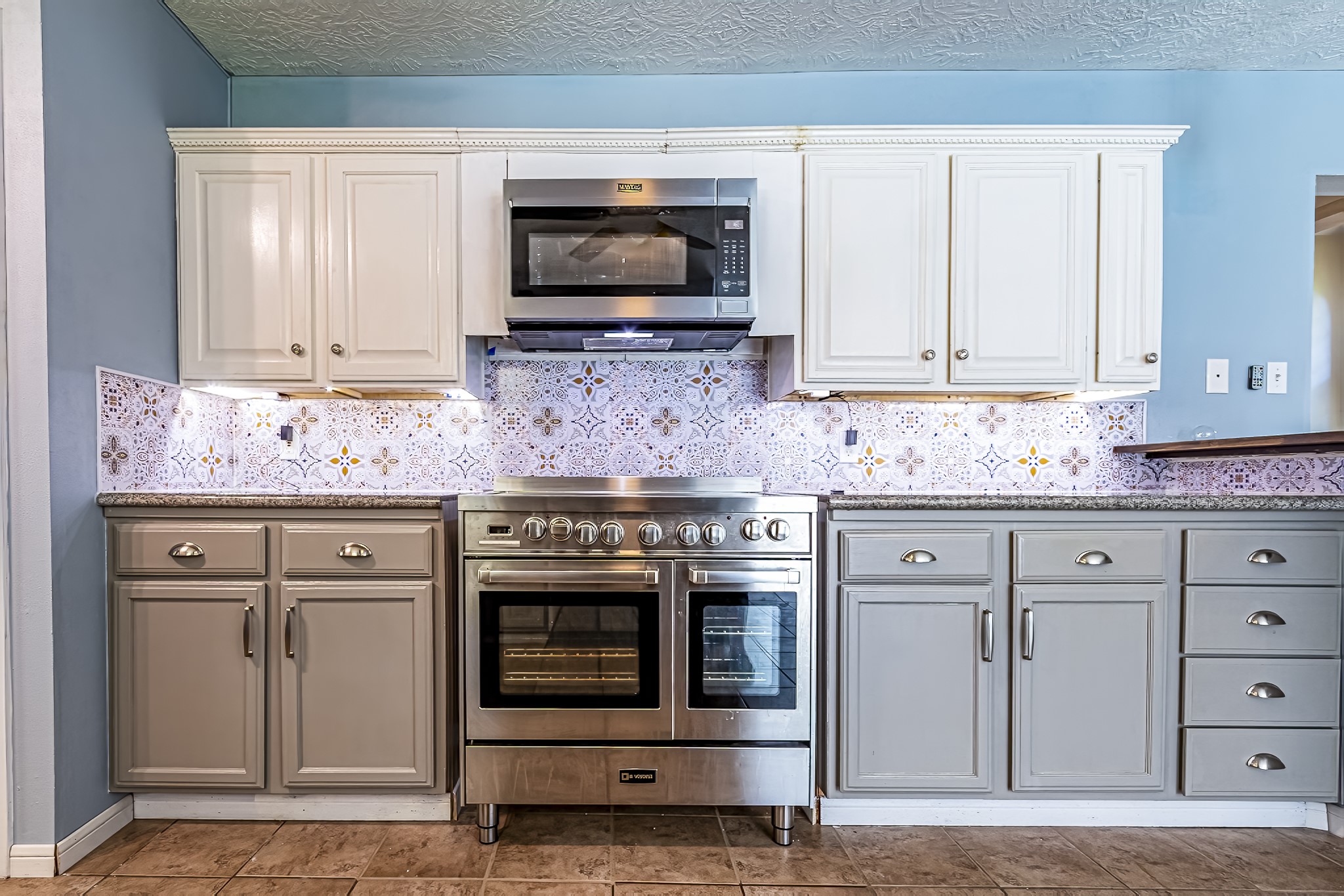 12 Quiet Wind Trinity, TX 75862 - Photo 29 of 47 a kitchen with granite countertop a stove microwave and cabinets