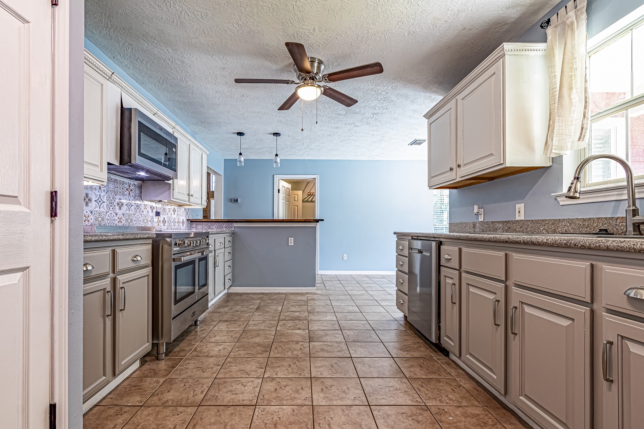 12 Quiet Wind Trinity, TX 75862 - Photo 30 of 47 a kitchen with stainless steel appliances granite countertop a stove top oven a sink a counter top space and cabinets
