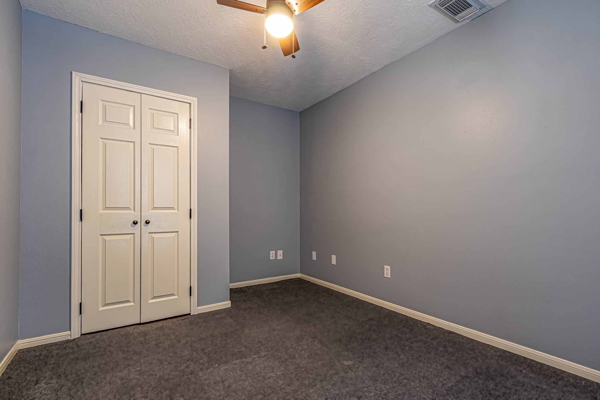 12 Quiet Wind Trinity, TX 75862 - Photo 37 of 47 an empty room with a chandelier fan and windows