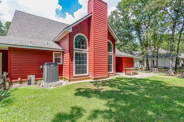 a view of a house with backyard porch and sitting area