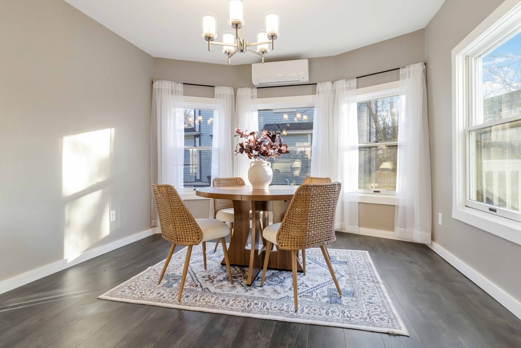 12 Cottage Street Stoneham, MA 02180 - Photo 3 of 16 a dining room with wooden floor and chandelier