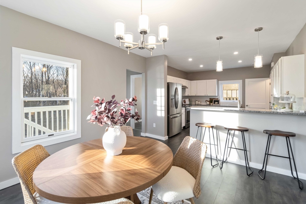 12 Cottage Street Stoneham, MA 02180 - Photo 4 of 16 a view of a dining room with furniture a chandelier and wooden floor
