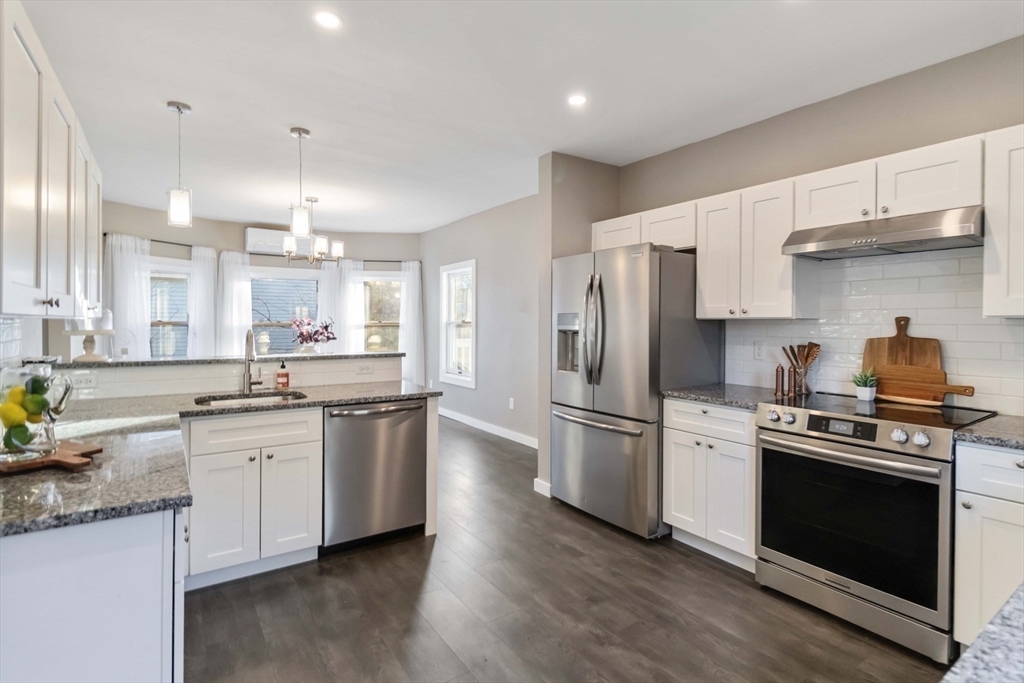 12 Cottage Street Stoneham, MA 02180 - Photo 5 of 16 a kitchen with stainless steel appliances a stove a sink and a refrigerator
