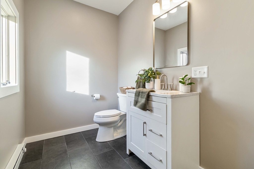 12 Cottage Street Stoneham, MA 02180 - Photo 7 of 16 a bathroom with a toilet sink and mirror