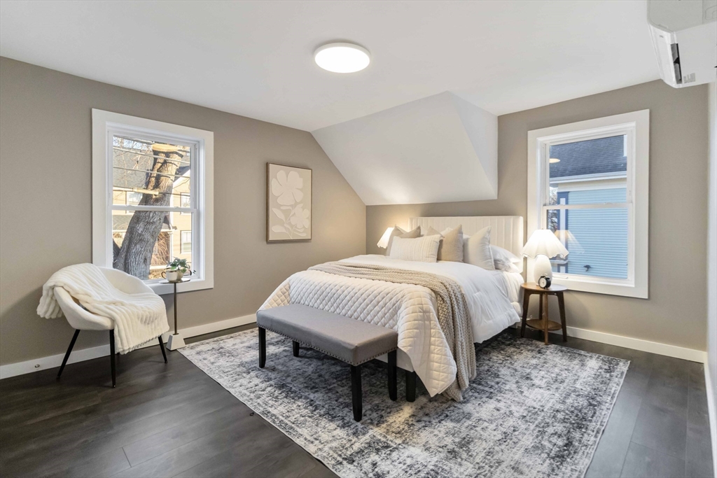 12 Cottage Street Stoneham, MA 02180 - Photo 8 of 16 a bedroom with a bed and wooden floor