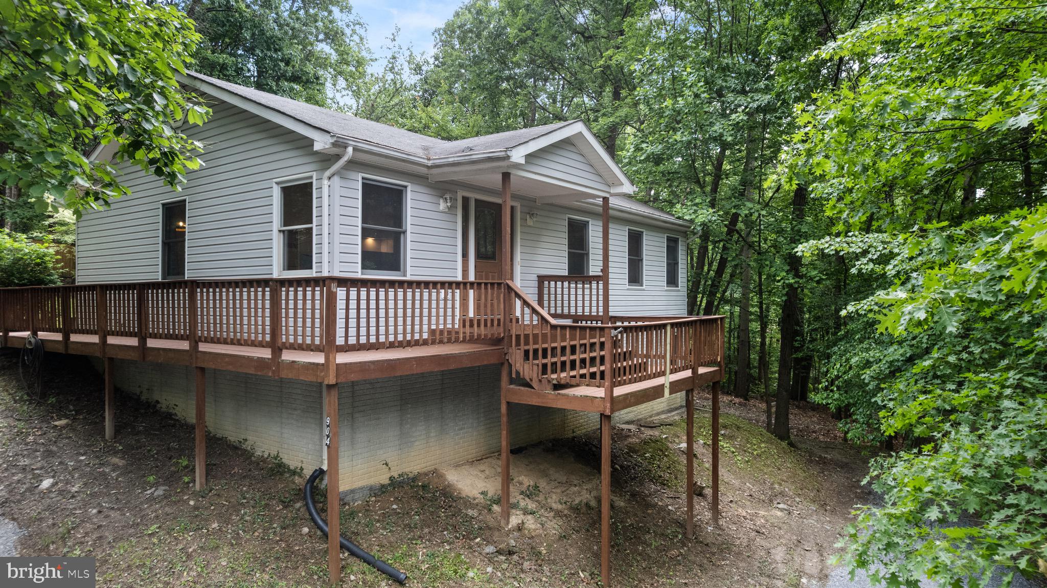 904 Wild Turkey Road Harpers Ferry, WV 25425 - Photo 1 of 1 a view of a house with a wooden deck and a yard