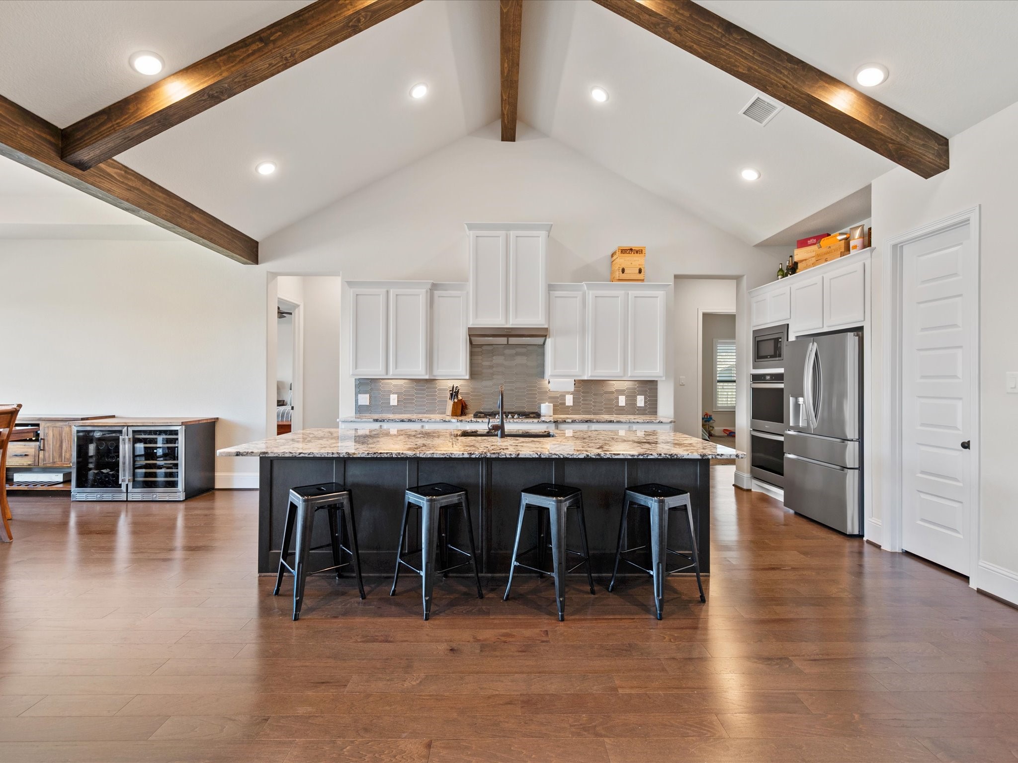 605 Ashbrook Ridge Lane Pinehurst, TX 77362 - Photo 11 of 46 The heart of the home — a kitchen that opens seamlessly to the warm and welcoming living room.