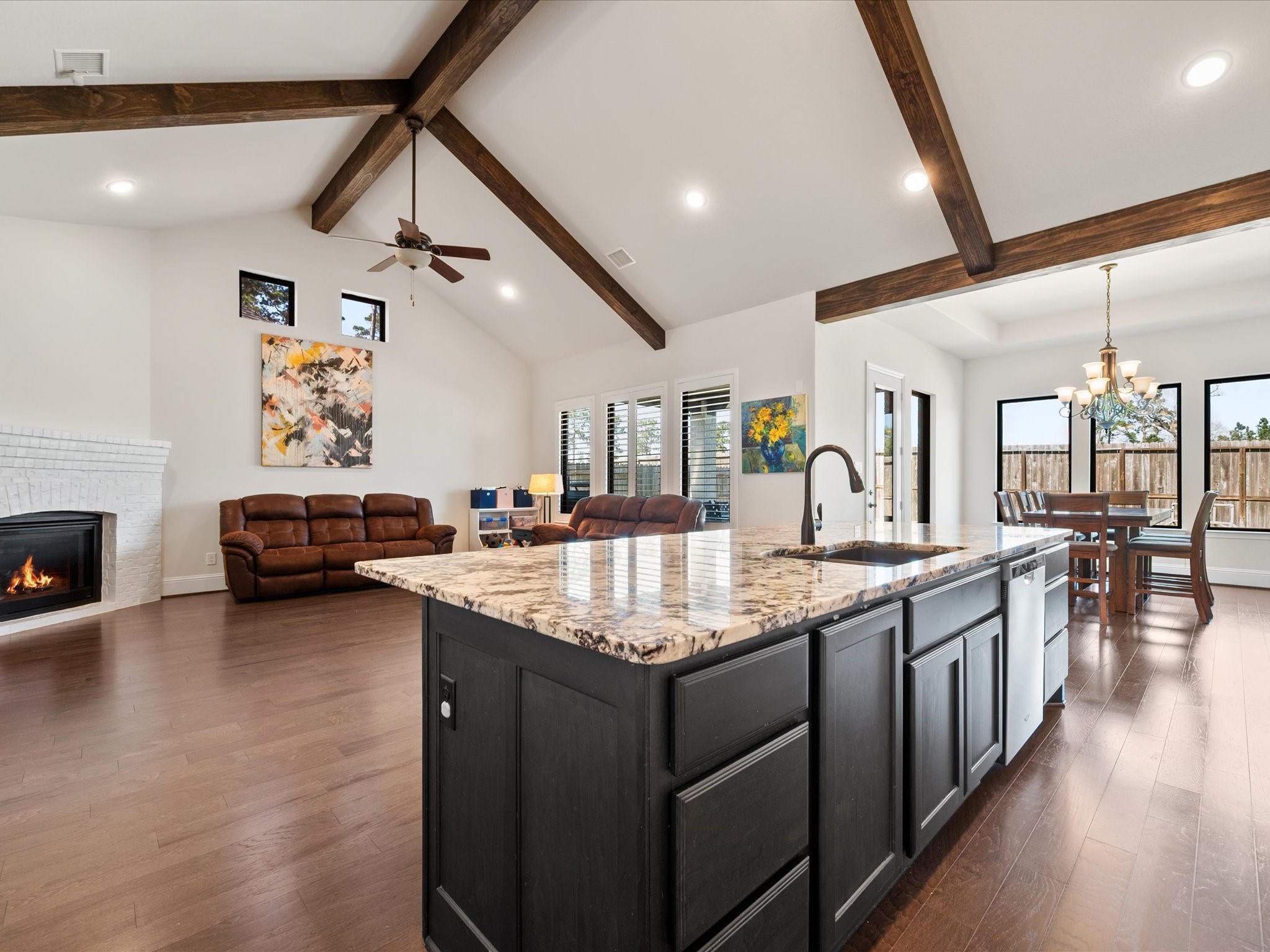 605 Ashbrook Ridge Lane Pinehurst, TX 77362 - Photo 12 of 46 An expansive center island with pots and pans drawers and a breakfast bar overlooks the living space, making everyday living and entertaining effortless.