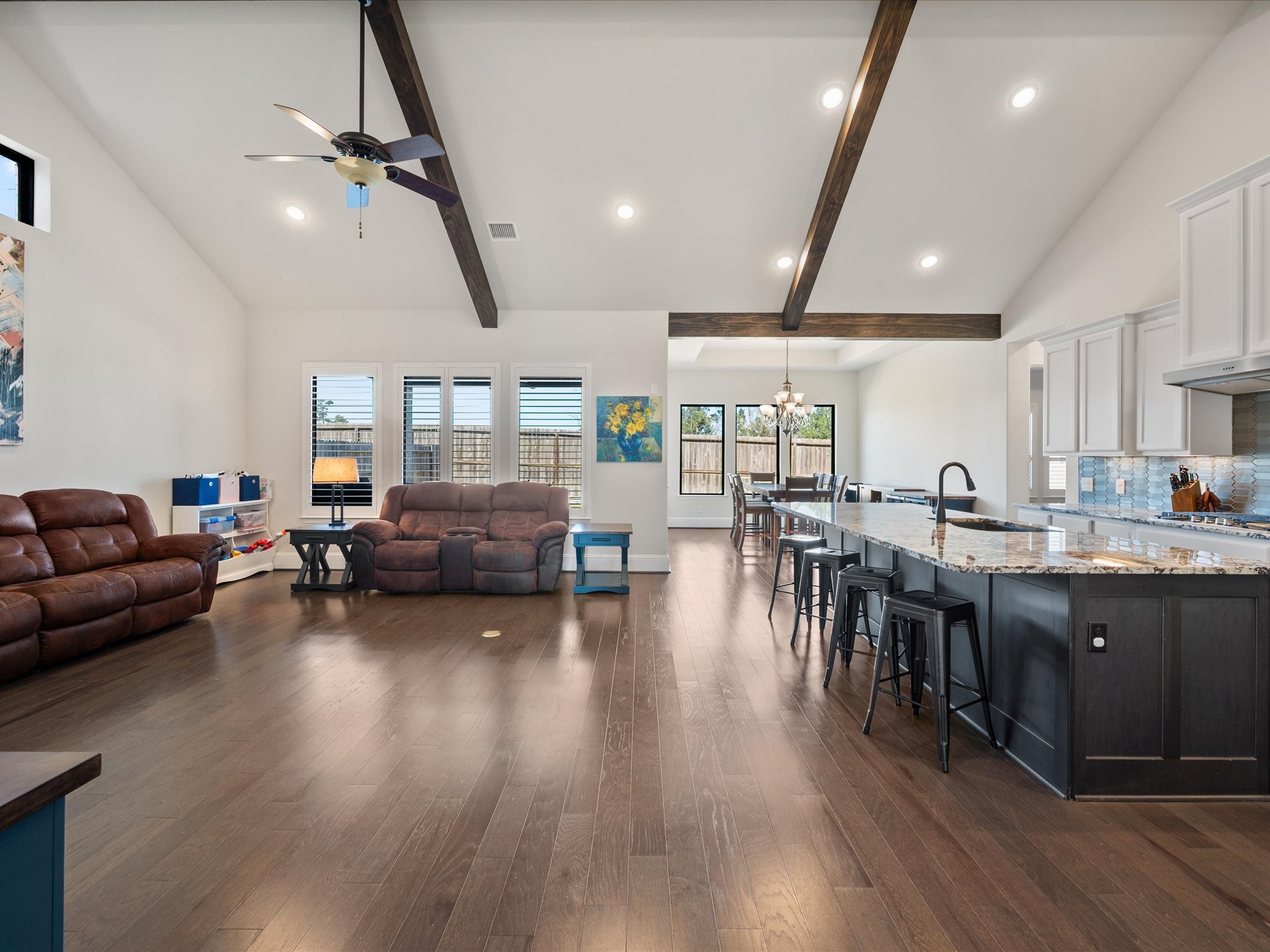 605 Ashbrook Ridge Lane Pinehurst, TX 77362 - Photo 13 of 46 Exposed beams, warm wood floors, and abundant natural light create a space that feels both refined and comfortable.