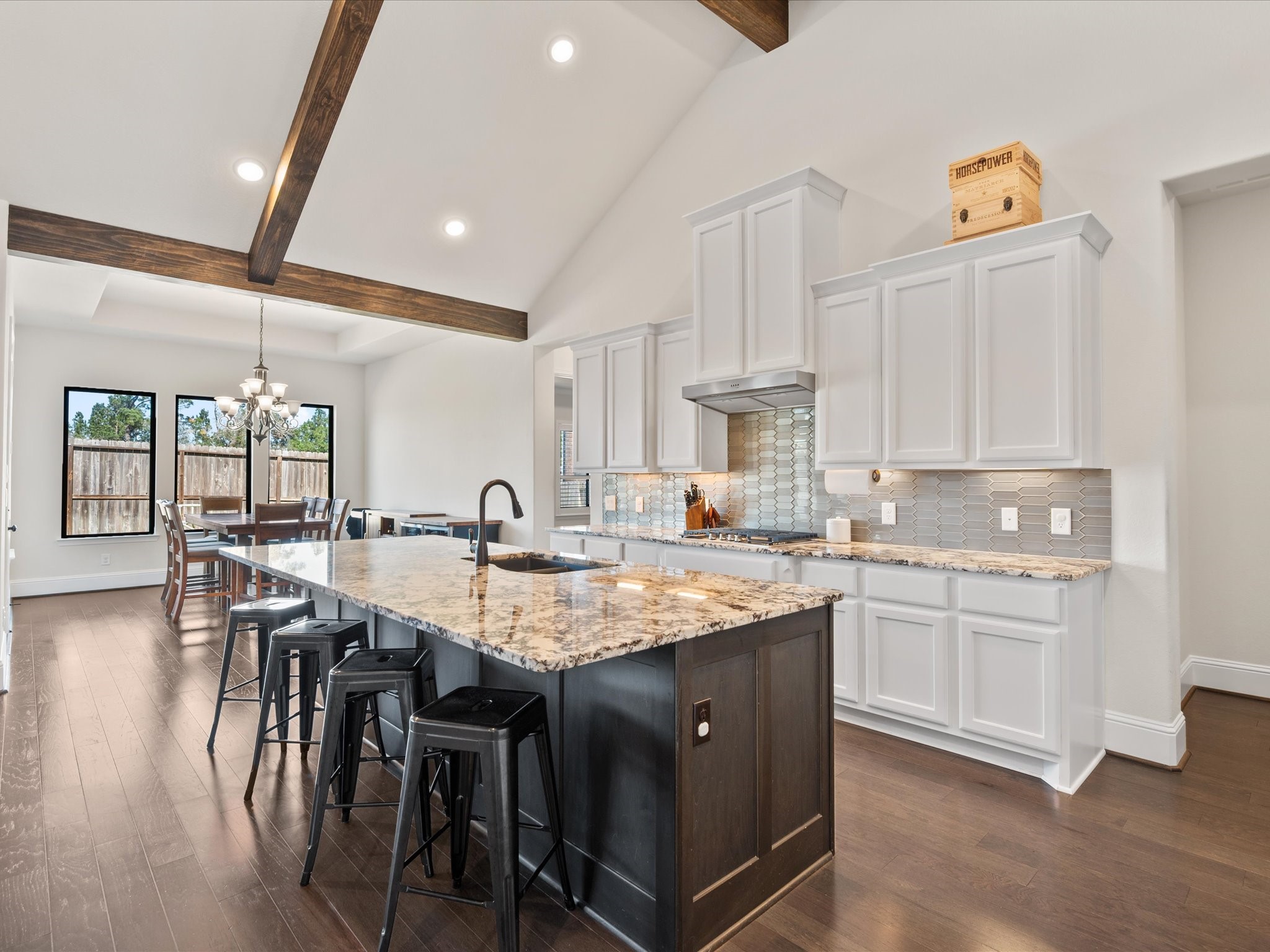 605 Ashbrook Ridge Lane Pinehurst, TX 77362 - Photo 16 of 46 Imagine your days unfolding here — morning coffee at the island, dinner prep with ease, and conversations that carry into the living room.