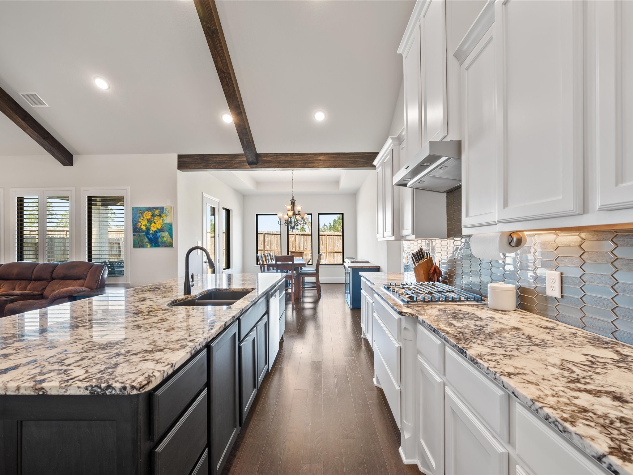 605 Ashbrook Ridge Lane Pinehurst, TX 77362 - Photo 17 of 46 Granite counters, under-cabinet lighting, and a stylish backsplash bring beauty and function together.