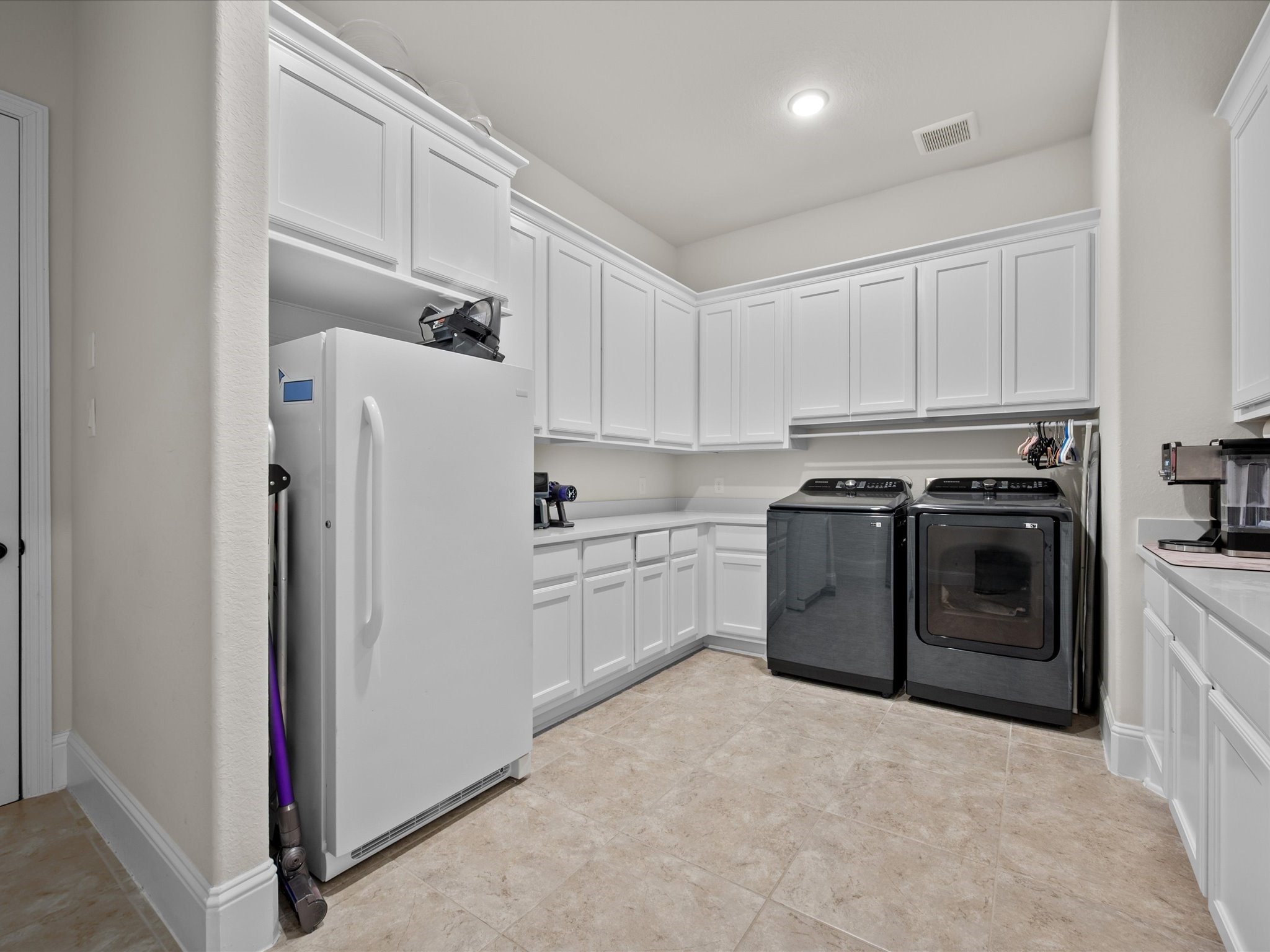 605 Ashbrook Ridge Lane Pinehurst, TX 77362 - Photo 33 of 46 An expansive laundry room provides ample storage space and room for an additional refrigerator if desired.