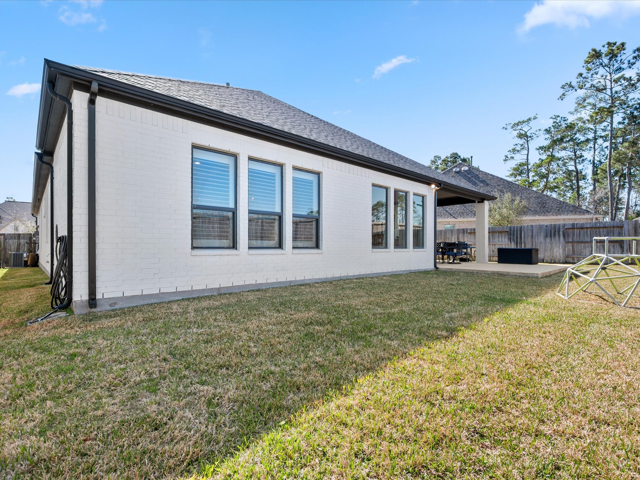 605 Ashbrook Ridge Lane Pinehurst, TX 77362 - Photo 36 of 46 Picture evenings under the covered patio, weekend barbecues, and room to run and play — this backyard is ready for the memories you’ll create here.