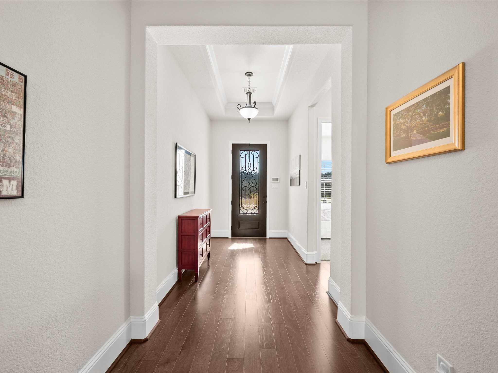 605 Ashbrook Ridge Lane Pinehurst, TX 77362 - Photo 9 of 46 Modern design meets timeless comfort with soaring ceilings, rich wood flooring, and elegant architectural details throughout.