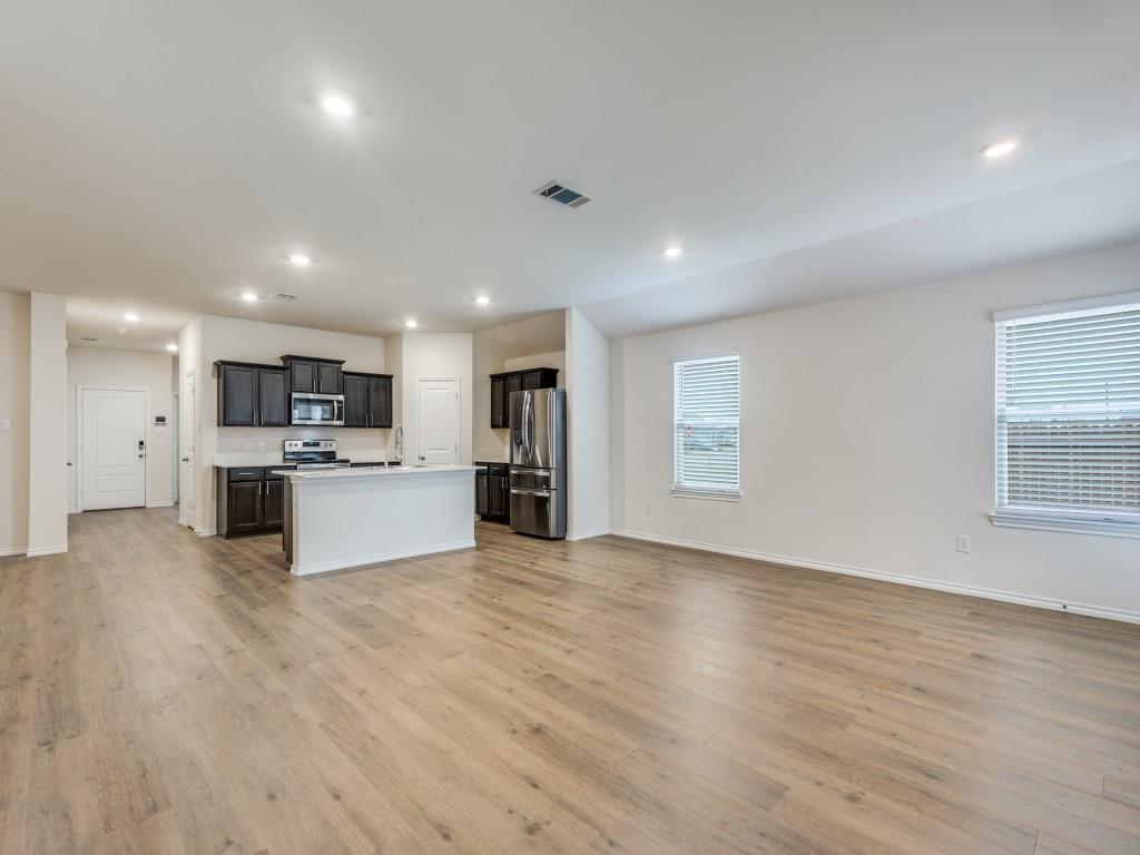 829 Primrose Lane Pilot Point, TX 76258 - Photo 11 of 37 a view of kitchen with stainless steel appliances refrigerator oven and white cabinets with wooden floor