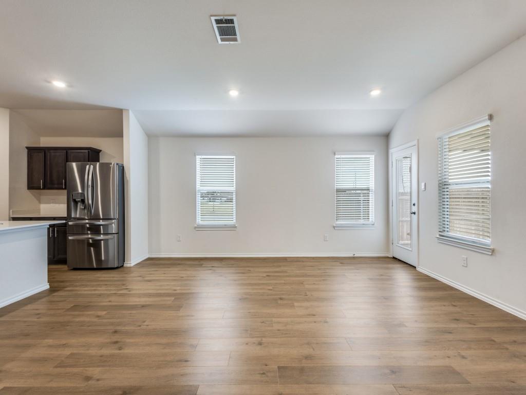 829 Primrose Lane Pilot Point, TX 76258 - Photo 13 of 37 a view of an empty room with window and wooden floor