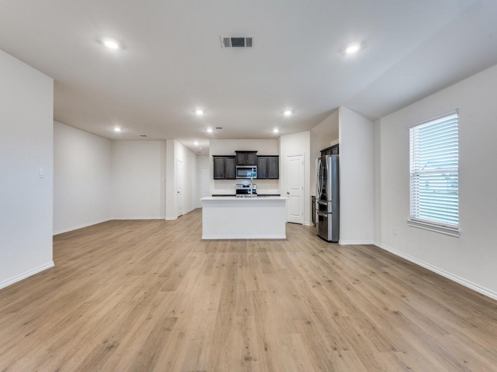 829 Primrose Lane Pilot Point, TX 76258 - Photo 14 of 37 a view of a kitchen with a sink and a refrigerator