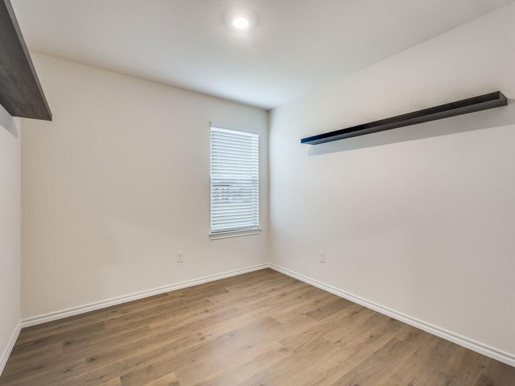 829 Primrose Lane Pilot Point, TX 76258 - Photo 21 of 37 an empty room with wooden floor and windows