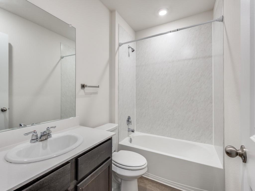 829 Primrose Lane Pilot Point, TX 76258 - Photo 22 of 37 a bathroom with a sink toilet and shower
