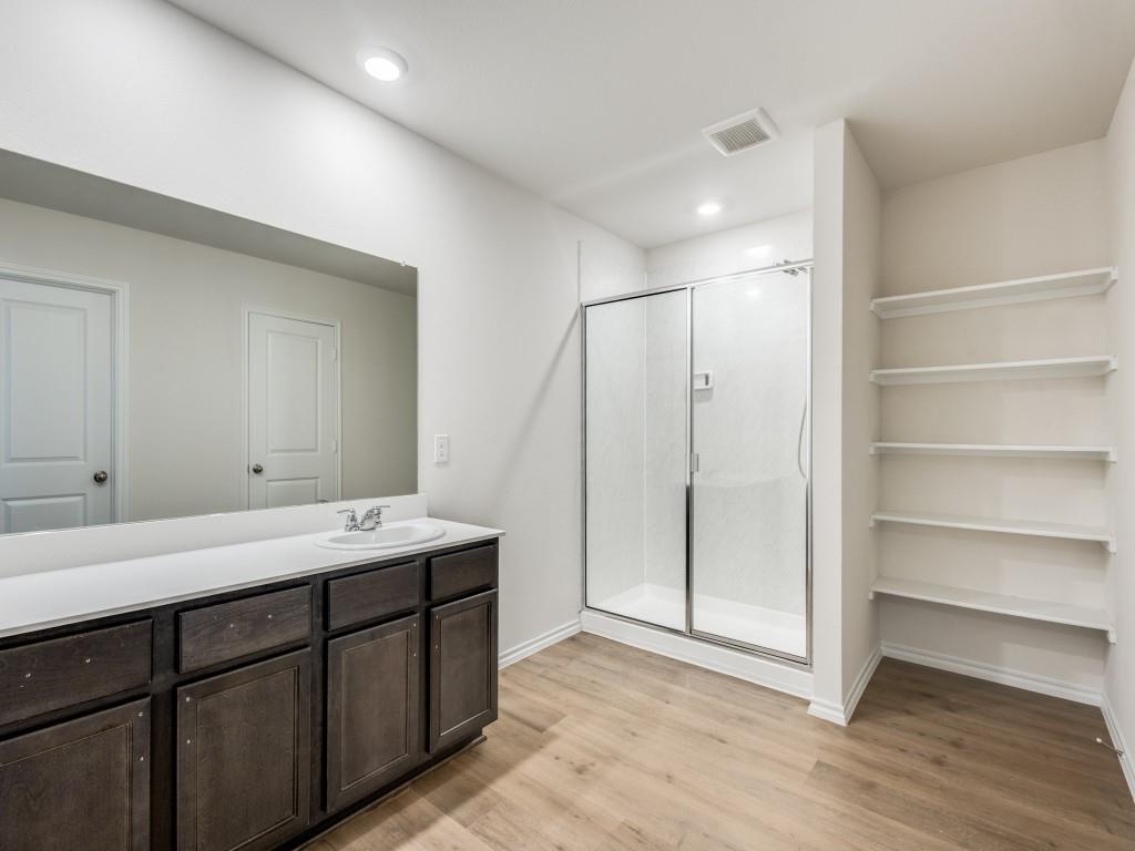829 Primrose Lane Pilot Point, TX 76258 - Photo 27 of 37 a bathroom with a double vanity sink and mirror