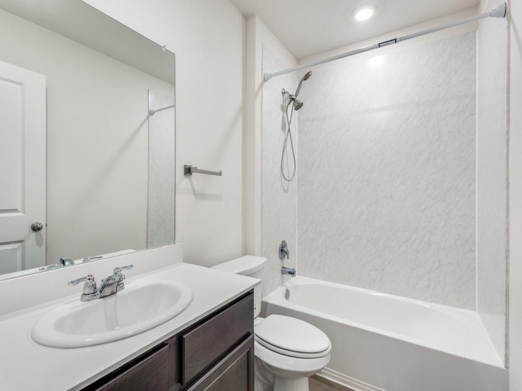829 Primrose Lane Pilot Point, TX 76258 - Photo 31 of 37 a bathroom with a sink toilet and shower