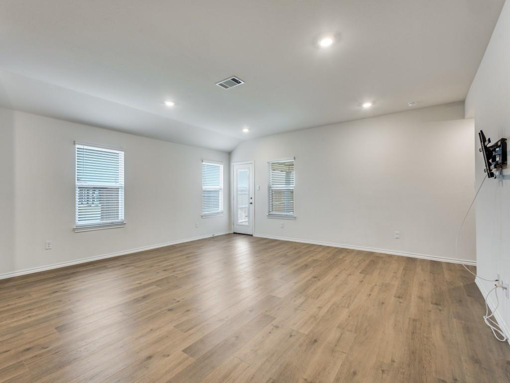 829 Primrose Lane Pilot Point, TX 76258 - Photo 6 of 37 an empty room with wooden floor and windows
