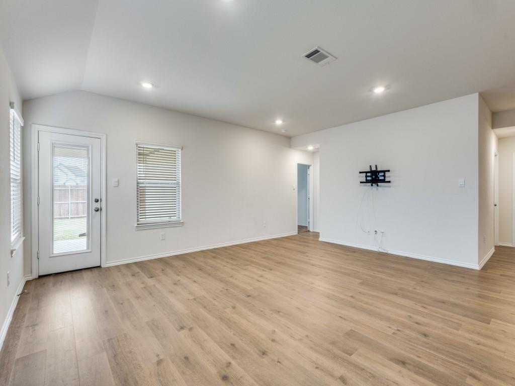 829 Primrose Lane Pilot Point, TX 76258 - Photo 7 of 37 a view of an empty room with wooden floor and a window