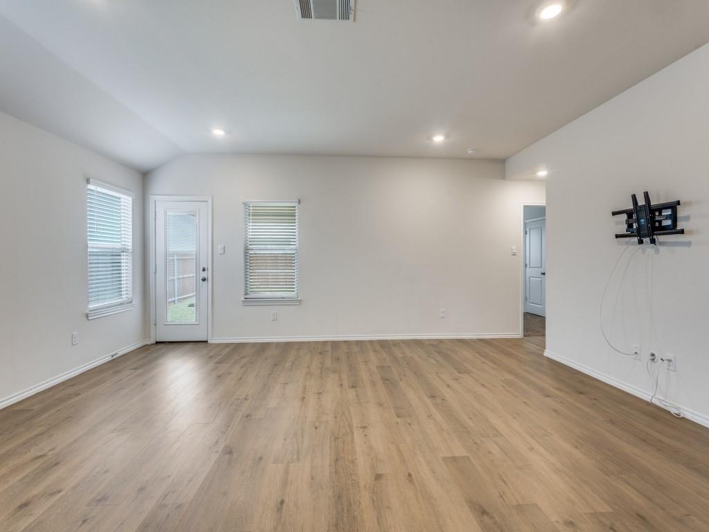 829 Primrose Lane Pilot Point, TX 76258 - Photo 8 of 37 an empty room with wooden floor and windows