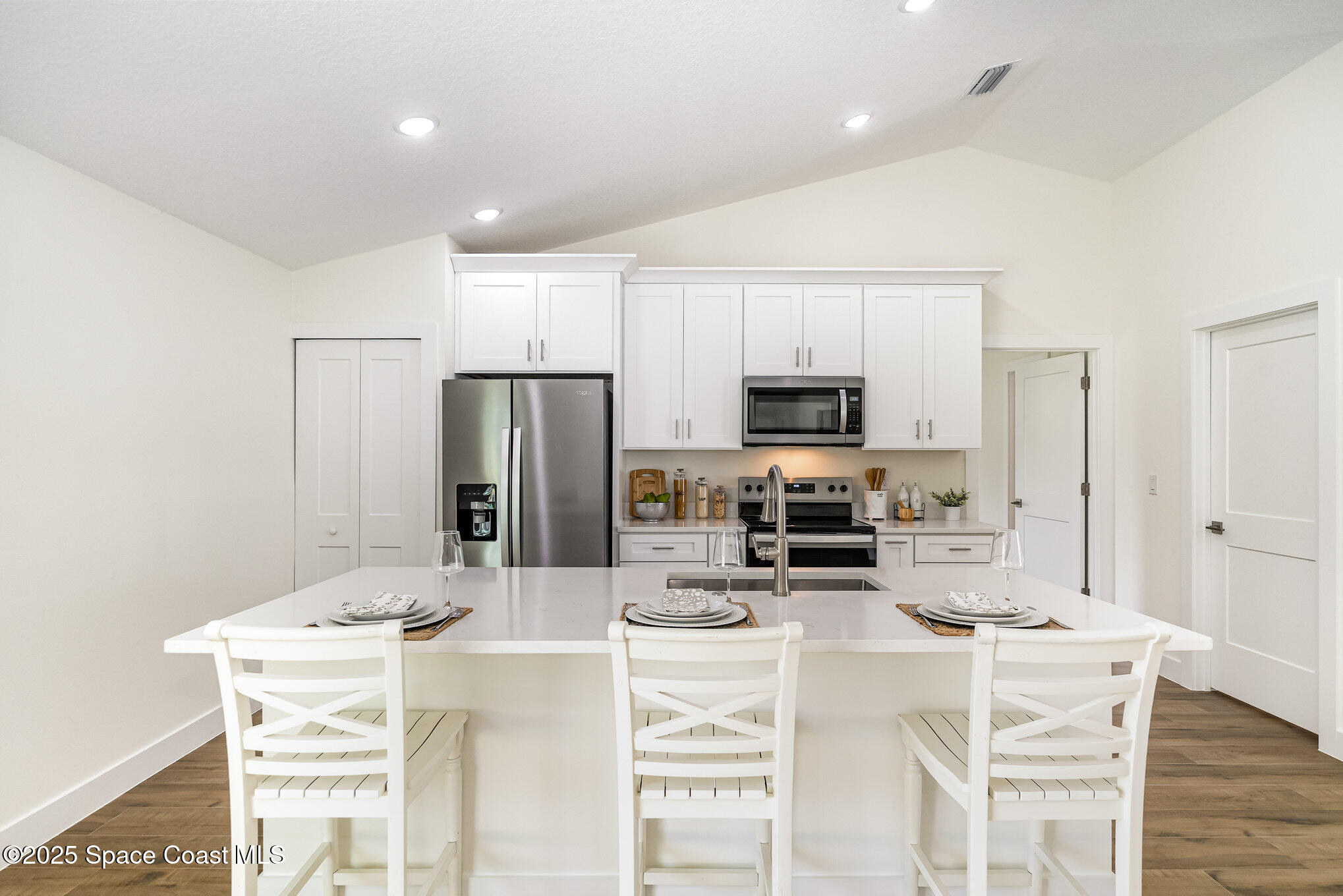 6003 Gilson Avenue Cocoa, FL 32927 - Photo 12 of 27 a kitchen with stainless steel appliances kitchen island granite countertop a refrigerator and microwave